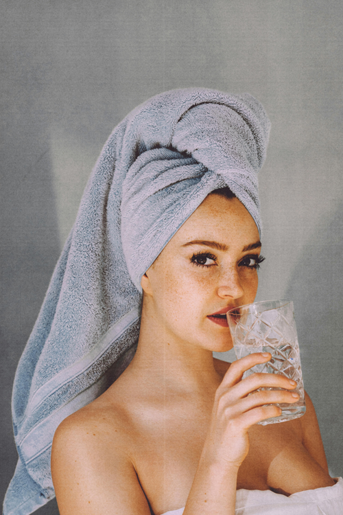 A women with a glass of water in her hand.